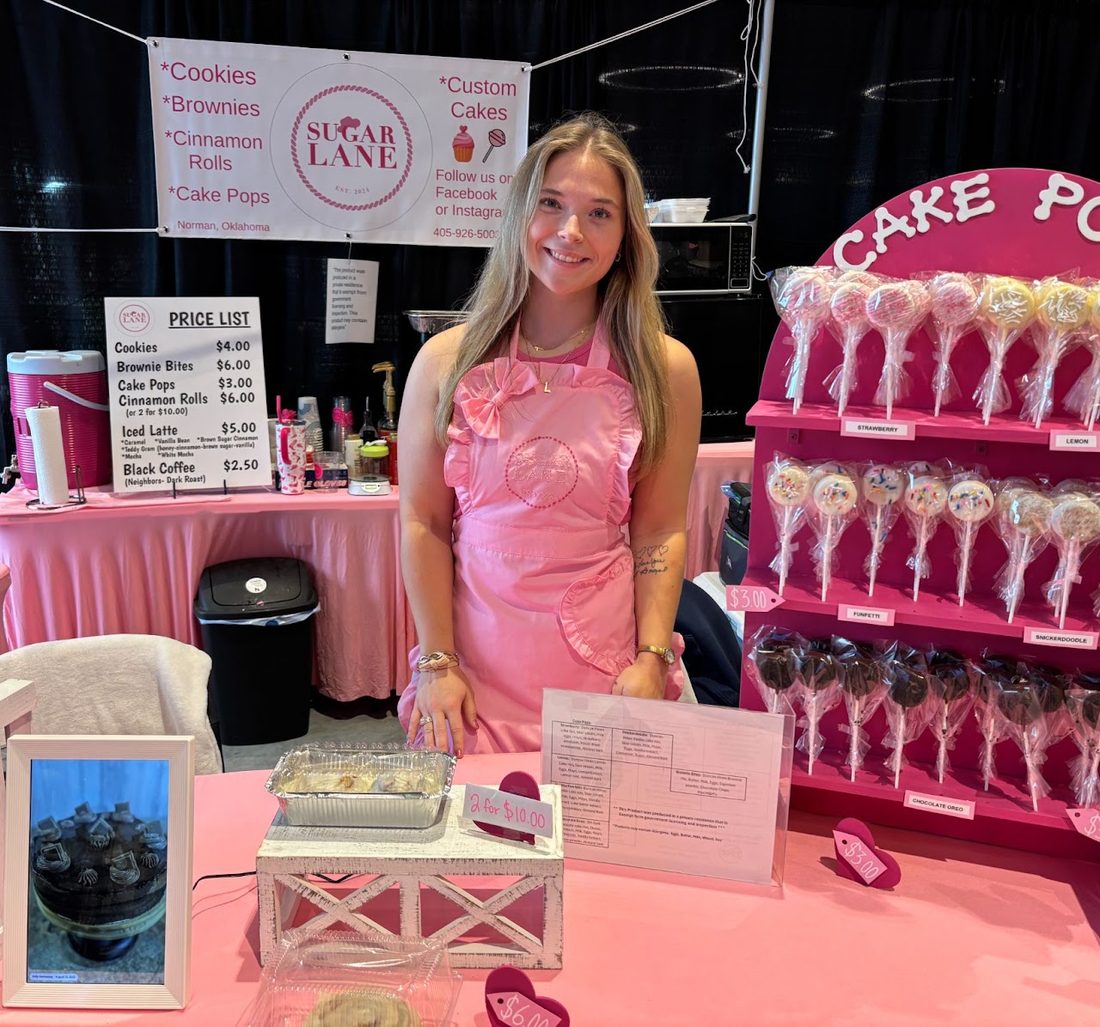 Laney in her pink apron at the Sugar Lane booth